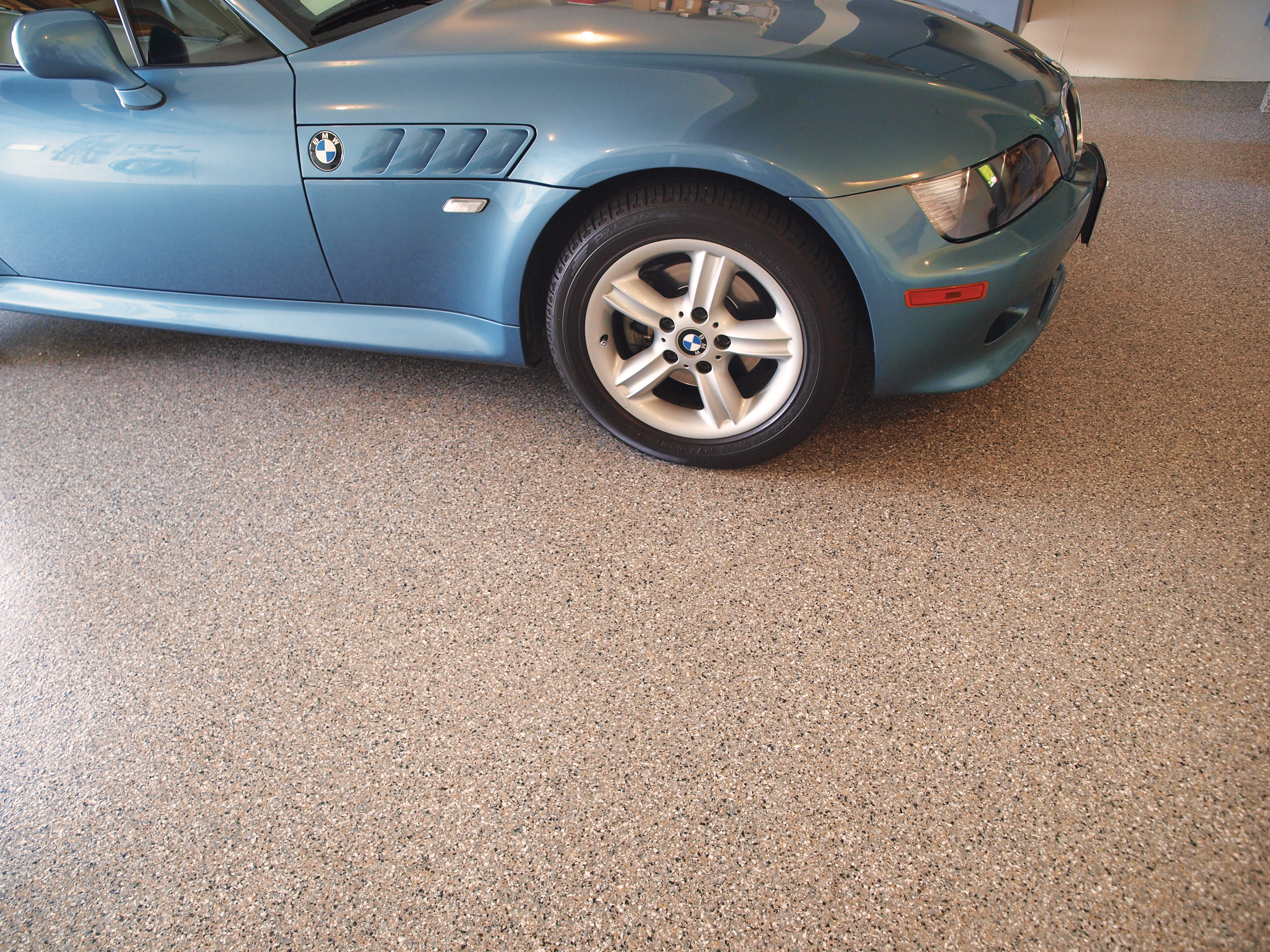 Blue BMW parked in a garage